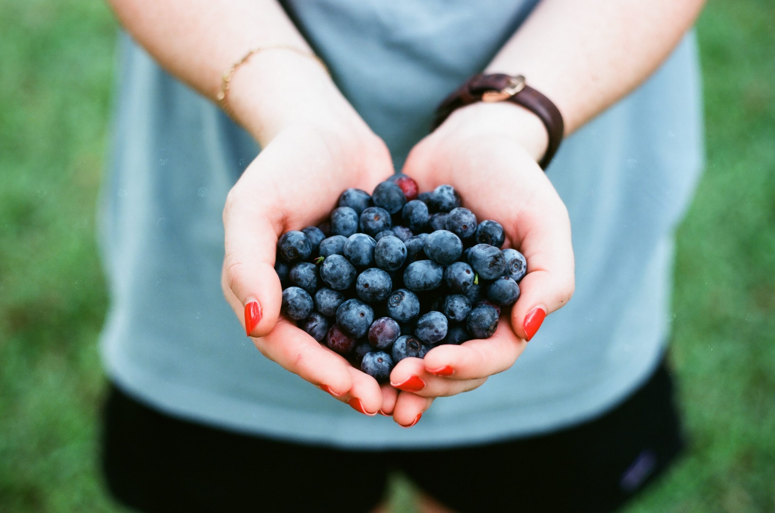 Woman Holding Blueberries