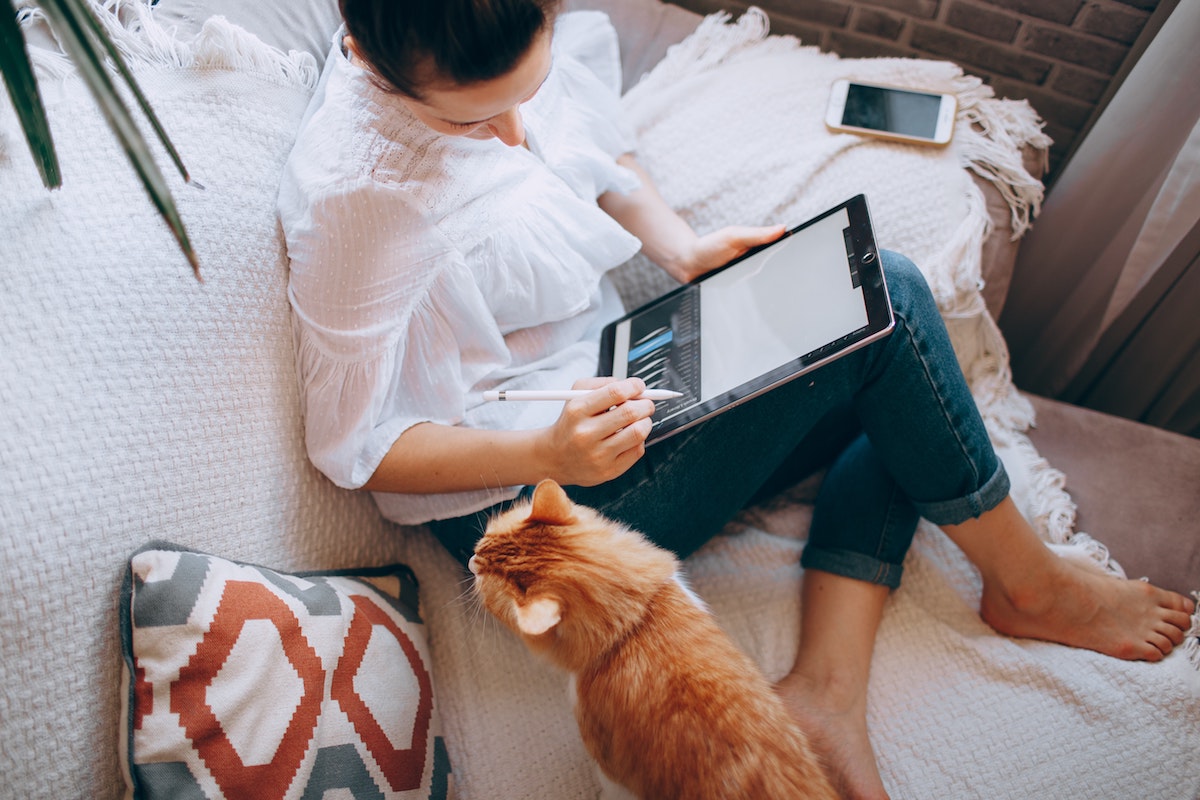 Woman working on couch 